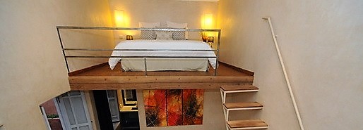 bedroom of the riad with carved wooden furniture, book a riad in Marrakech medina with hammam, patio and rooftop terrace