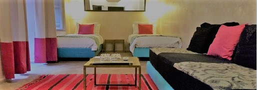 double bedroom of the riad in warm tones, book a riad in Marrakech medina for a small group in a private house